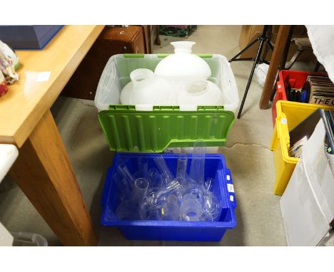 A large quantity of glass oil lamp shades together with clear glass chimneys 