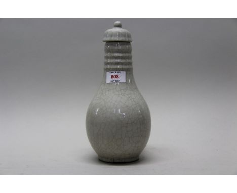 A Chinese crackle glazed blanc de chine vase and cover, possibly 18th century, 26.5cm high.   Condition Report:  Glaze chips 