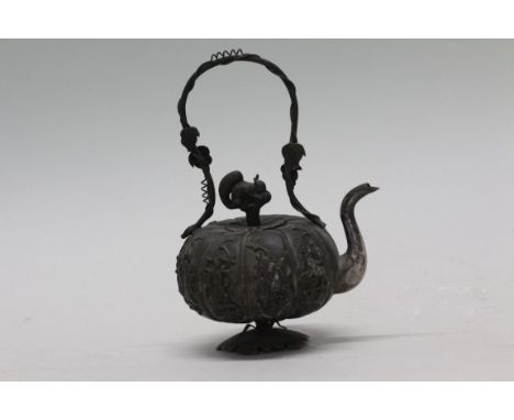 A Chinese silver wine ewer and cover, 19th century, of gourd form, the lobed body decorated in relief with eight immortals, w