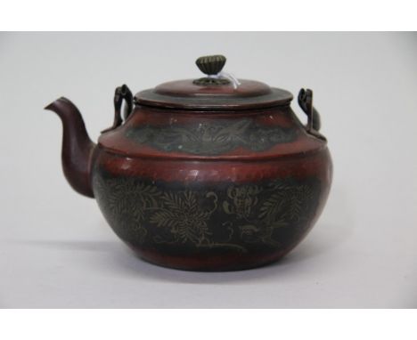 An Oriental metal teapot and cover, probably 19th century, 10.5cm high.