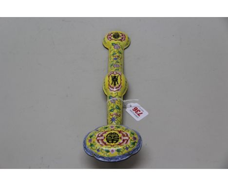 A Chinese canton enamel yellow ground famille rose ruyi sceptre, 35.5cm long.