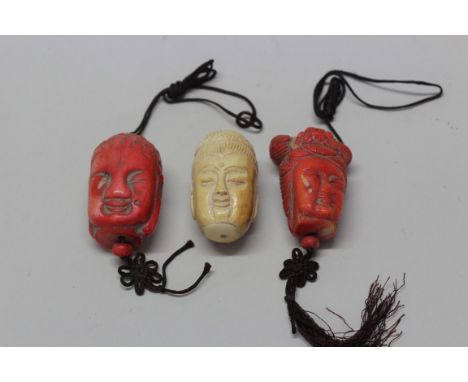 Two similar Chinese coral head pendants or scroll weights, one depicting a buddha, the other possibly Guanyin, 4.5cm; togethe