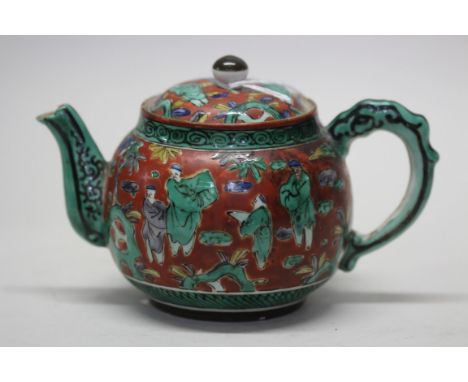 A Chinese red ground famille verte teapot and cover, 19th century, 11.5cm high.