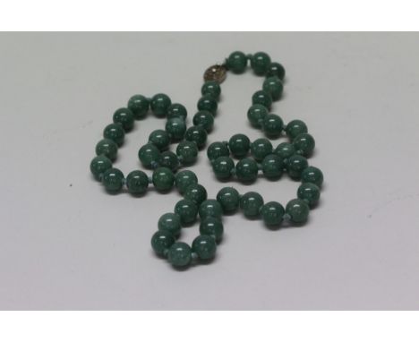 A sage green jade bead necklace.