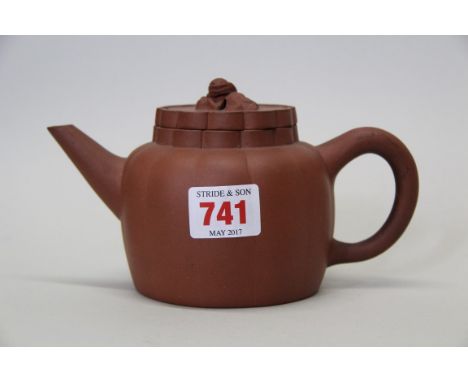 A Chinese yixing teapot and cover, hall mark to base, of lobed form with qilin finial, 10cm high.