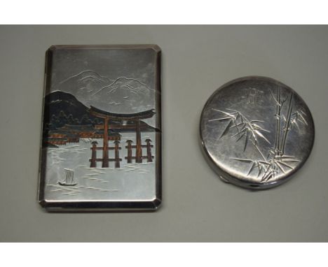 A Japanese silver niello cigarette case, stamped 'silver 950 Okubo', decorated a mountainous river landscape, 63g; together w