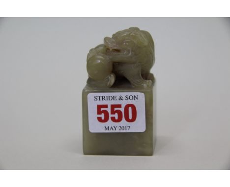 A celadon jade seal, surmounted with a dog of fo, with plain base, 7cm high.