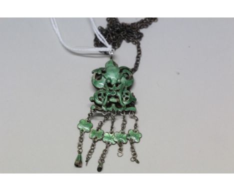 A green enamel pendant.
