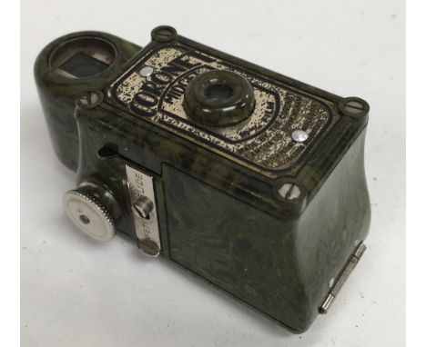 A 1920s olive green bakelite Cornonet midget camera.