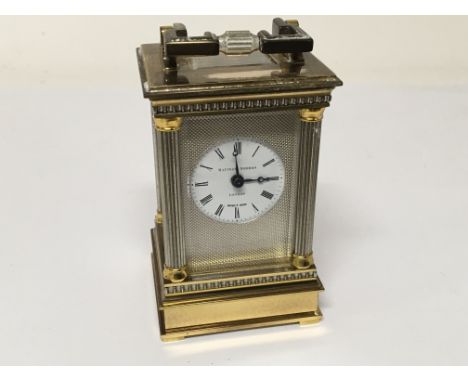 A miniature brass carriage clock with pillars to each corner the dial with Mathew Norman London - NO RESERVE