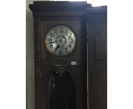 A large oak long case clock with a silvered dial visible pendulum and weights - NO RESERVE