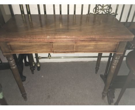 A mahogany card table the twin flap top above ring turned legs - NO RESERVE
