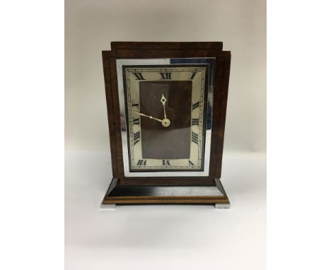 An Art Deco design walnut veneered mantle clock by A.J.Wares Ltd, South Shields. H.19.5cm