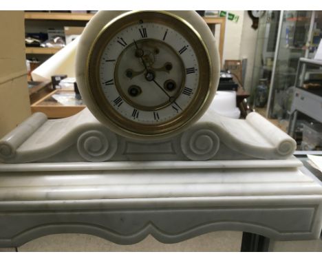 A white marble mantle clock the enamel dial with Roman numerals and visible escapement.28 cm.