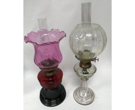 A cut glass oil lamp and a ruby glass oil lamp.