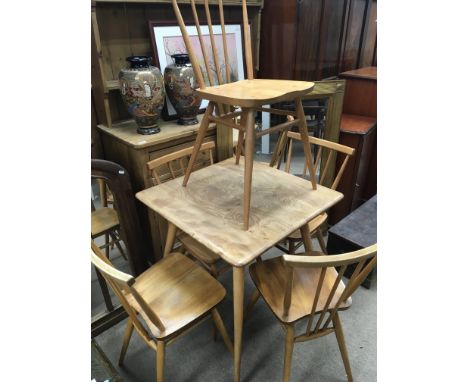 A light elm and oak Ercol kitchen table with four matching chairs. The table top has a few marks chairs a few scratches other