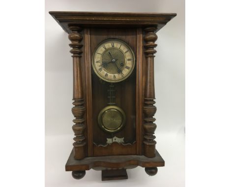 A wooden cased wall clock with brass dial.Approx 60cm - NO RESERVE