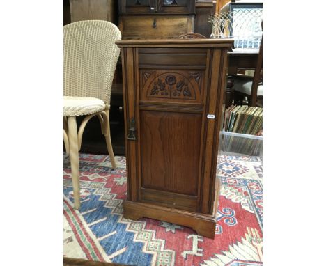 A  Edwardian mahogany pot cupboard with single door on bracket feet .