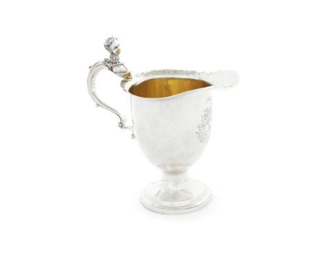 A good and unusual George III silver cream jug by Thomas Heming, London, 1774
The scroll handle terminating in a female head 