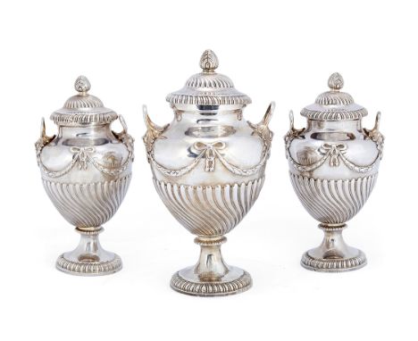 A set of three George III vase-shaped silver tea caddies, maker's mark indistinct, London, 1769
Of ovoid, part spirally flute
