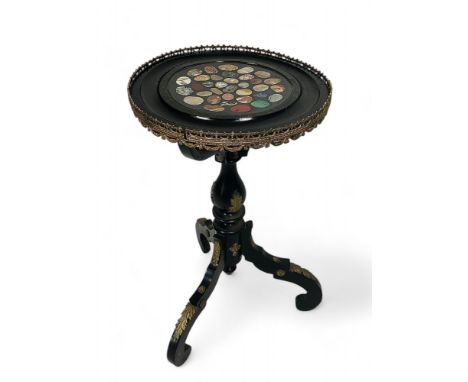 A 19th century ebonised table with associated pietre dure top
Applied with gilt metal mounts, the dished top with pierced thr
