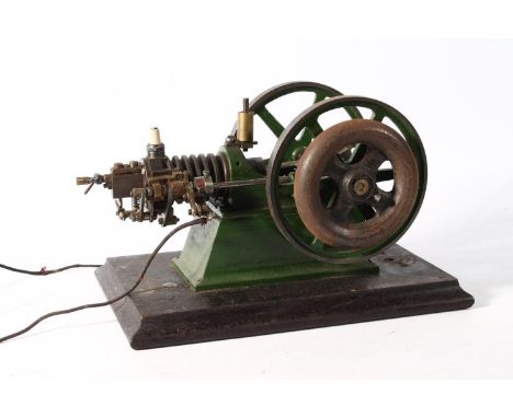 Cast metal model of a static engine, raised on wooden plinth, 27cm long. 
