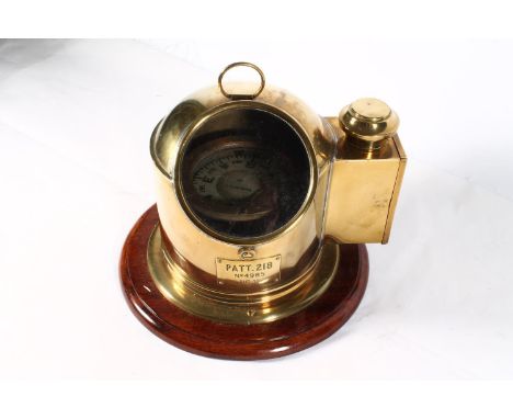 Ships brass binnacle compass with plaque incised 'PATT 218 No4985 BHS-YG', raised on circular mahogany base, 27cm tall. 