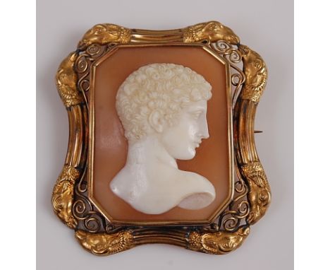 A yellow metal carved shell cameo brooch, of octagonal form, depicting the profile of a Roman man within an openwork and engr