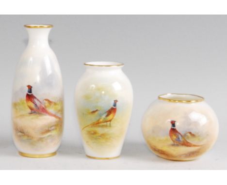 A Royal Worcester porcelain bottle vase, shape No.2491, decorated with cock and hen pheasant, black mark, h.14.5cm; and two o