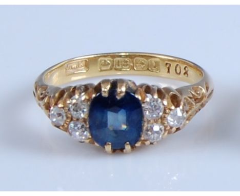 An 18ct yellow gold, sapphire and diamond ring, the cushion cut sapphire measuring approx 6.8 x 5.6 x. 3.9mm, weight estimate