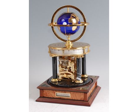 A Franklin Mint Royal Geographical Society Millennium Clock, the gilded blue glass globe orbited by the moon, within two circ