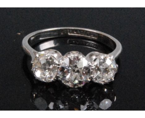 A platinum and diamond three stone ring, comprising three Old European cut diamonds in claw settings, centre diamond dimensio