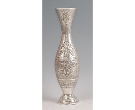 An early 20th century Persian white metal vase, of tulip shape, having all-over foliate engraved decoration, the centre panel