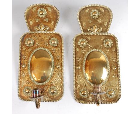 A pair of Dutch embossed brass single light wall sconces, each decorated with stylised flowers in the 17th century style, gro