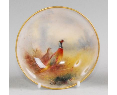 A Royal Worcester porcelain footed dish, decorated with a cock and hen pheasant in a landscape by Jas. Stinton, shape No.2769