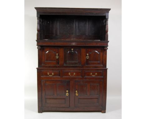 An antique Welsh joined oak tridarn, the upper section having a four-panel back bearing date 1634 within pierced and panelled