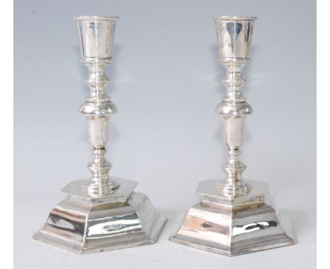 A pair of silver candlesticks in the 17th century style, having multi-knopped columns to domed hexagonal loaded bases, maker 