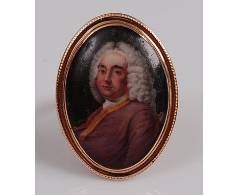 A Geo III rose gold hand-painted miniature portrait ring, depicting a gentleman within a rope edge border, portrait dimension