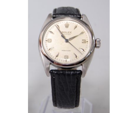 A gent's steel cased Rolex Oyster Precision manual wind wristwatch, circa 1952, having a signed champagne dial with baton mar