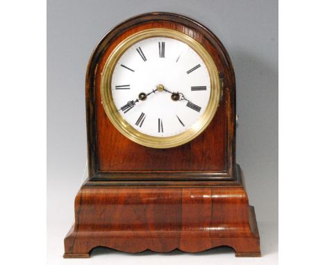 A Victorian rosewood dome topped mantel clock, having an unsigned white enamel dial, twin winding holes for an eight day wire