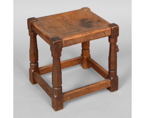 ROBERT THOMPSON OF KILBURN - EARLY MOUSEMAN STOOL. An oak stool with a solid leather seat and supported on octagonal legs joi