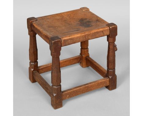 ROBERT THOMPSON OF KILBURN - EARLY MOUSEMAN STOOL. An oak stool with a solid leather seat and supported on octagonal legs joi