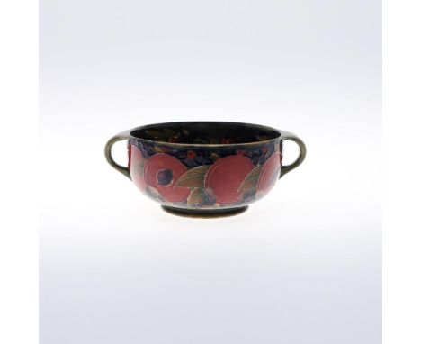 ANTIQUE MOORCROFT BOWL - POMEGRANATE. A two handled bowl in the Pomegranate design  on a blue and green ground. Painted mark 