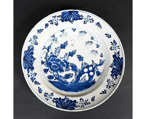 ANTIQUE DELFT BLUE & WHITE CHARGER. An 18thc delft charger, painted to the well with flowering trees and foliage, the rim wit