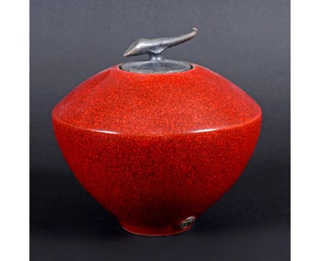 TIM ANDREWS (B 1960) - RAKU LIDDED JAR. (d) A conical raku jar with a horn shaped finial and red sang de boeuf crackle glaze,