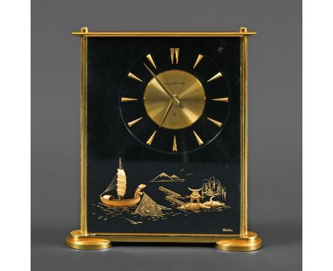 JAEGER LE COUTRE 'MARINA' CLOCK. A rectangular shaped clock with a lucite case and brass edges and feet. With a 4 inch dial w