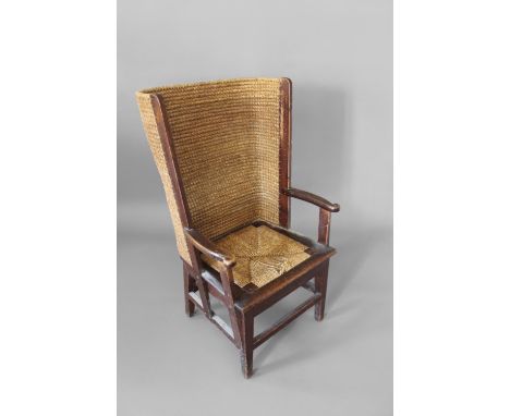 ARTS &amp; CRAFTS ORKNEY CHAIR. An antique stained pine chair with a curved woven back, the chair with scroll arms and a drop