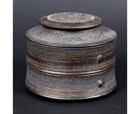 JASON WASON (B 1946) - LIDDED POT. (d) With a dome top lid, horizontal bands and lugs to each side. Covered in a black and go