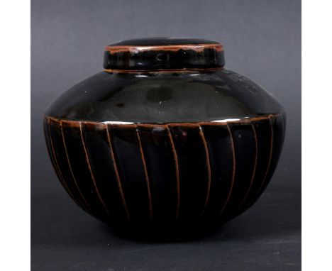 DAVID LEACH (1911-2005) - LIDDED STONEWARE JAR. (d) A lidded stoneware jar with fluted body and tenmoku glaze. 'DL' seal mark