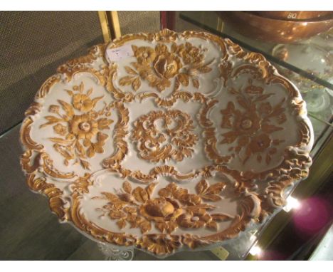 A Meissen plate, moulded with gilt and foliage, and a 19th century Majolica teapot moulded with apple blossom (2)  